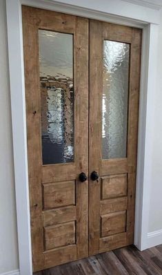 two wooden doors with mirrored glass on the front and side panels in an empty room