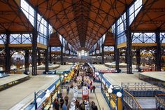 an overhead view of people walking around in a train station with lots of large windows