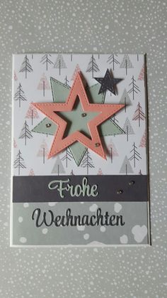 a close up of a greeting card with a star on the front and trees in the back