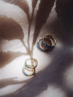 The prettiest blue opal hoops to sweeten your earlobes. These gold and cerulean blue opal huggie hoops shimmy and dance in the light day and night. Team them with with each other or mix and match with our other favorite hoop earrings. ✦ Choose your pair from two different sizes ✦✦ DETAILS ✦✧ Name: Kehaulani (keh-HOU-lah-nee) - Dew from the sky.✧ You will receive 1 pair.✧ Size 1: 10.5 x 2.25mm thick; 8.25mm inner diameter.✧ Size 2: 12.5 x 2.25mm thick; 9.75mm inner diameter.✧ Gold Plated Sterling Blue Huggie Hoop Earrings, Blue Small Hoop Huggie Earrings, Blue Hypoallergenic Small Hoop Huggie Earrings, Hypoallergenic Blue Small Hoop Huggie Earrings, Blue Small Hoop Huggie Earrings For Everyday, Blue Hypoallergenic Small Hoop Jewelry, Hypoallergenic Blue Small Hoop Jewelry, Blue Hoop Huggie Earrings Gift, Blue Huggie Hoop Earrings For Gift