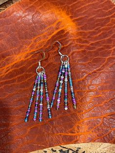 Multicolored seed beads on silver wire 2" Dangle Earrings With Silver Beads For Festivals, Silver Beaded Earrings With Dangling Beads For Festival, Silver Beaded Dangle Earrings For Festivals, Festival Dangle Earrings With Silver Beads, Bohemian Purple Earrings With Tiny Beads, Adjustable Heishi Beads Earrings With Ear Wire, Adjustable Multicolor Beaded Dangle Necklaces, Nickel Free Multicolor Beaded Necklace For Festivals, Nickel-free Multicolor Beaded Necklace For Festival