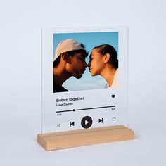 a clear acrylic photo frame with an image of a man and woman kissing