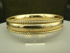 "excellent to like new preowned condition  Item Details 14K Yellow Gold  Size: 6.75\" Hallmarks: 14k Total Weight (grams): 22.45 Etched, Engraved & Polished Rope Edge Hinged Bangle Bracelet  Selling on eBay 18 years over 6000 positive feedback and will continue our quality customer service on Etsy. Buy with confidence This item will be shipped insured, and signature required We ship United States only. Each listing will display shipping charges for that item, and the manner it will be shipped. W Fine Jewelry Bracelets, Hinged Bangle, Selling On Ebay, Positive Feedback, Bangle Bracelet, Etching, Bangle Bracelets, Jewelry Watches, Jewelry Bracelets