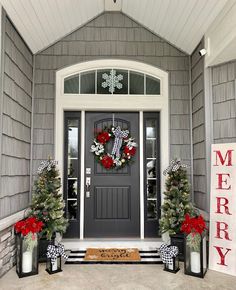 the front door is decorated for christmas with wreaths and decorations