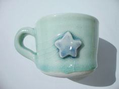 a ceramic cup with a star decoration on it