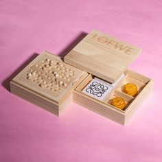 two wooden boxes filled with different types of buttons