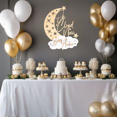 a table topped with lots of cake and balloons