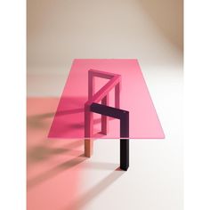 a pink table sitting on top of a white floor