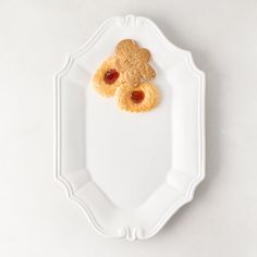 two heart shaped cookies on a plate with jelly in the shape of an oatmeal