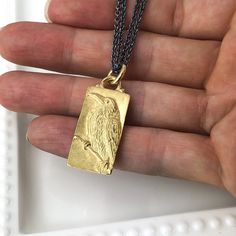 "This Raven pendant was hand carved in wax by Carrie who uses a microscope to create fine detail. It was then cast in 18k gold in her shop. The background has a soft satin finish while the high spots are polished to catch the light. It hangs on an 18\" Sterling Silver double chain that has a dark patina and is finished with an 18k Gold clasp. It measures 34mm x 14mm. Pendant weighs 14.35g." Raven Pendant, Fox Pendant, Turquoise Heart, Garnet Stone, Double Chain, Scottsdale Az, Unique Pendant, Unique Rings, Satin Finish