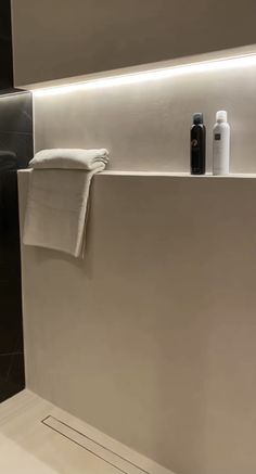 a white towel hanging on the side of a bath tub