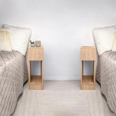 two beds side by side in a room with carpeted flooring and white walls