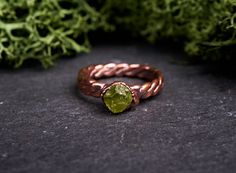 A braided copper band featuring a beautiful raw peridot gem. Because the gemstones used are natural and uncut, each ring is always unique and full of personality. ✦ MADE TO ORDER: ships in 1-2 weeks ✦ Express delivery: 2-7 labor days worldwide BAND SIZE: around 3 mm wide Because of the handcrafted nature of this item together with the uniqueness of each stone, the ring you'll receive may differ from the ones pictured in photo. Differences in the color, size and shape of the gemstones are normal. Unique Green Copper Ring, Electroformed Metal Rings For Gift, Nature-inspired Raw Stone Healing Jewelry, Rustic Bronze Electroformed Jewelry, Luxury Nature-inspired Electroformed Jewelry, Promise Band, Clear Nail Polish, Dark Copper, Ethical Jewelry