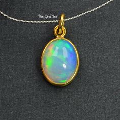 Thank you for coming in! Beautiful 18k solid gold charm pendants with natural crystal opals in oval shape full of play of color. Top shelf Ethiopian material with the most sought-after harlequin flash pattern! SIZE: Appr. 8mmx10mm opal bezel, 15mm total length, 4mm loop, 2.8mm holes MATERIAL: 18k Solid Yellow gold, Natural Opal Ethiopian Opal Cabochon Oval Pendant Jewelry, Ethiopian Opal Cabochon Oval Pendant, Luxury Ethiopian Opal Cabochon Oval Pendant, Ethiopian Opal Oval Pendant With Gemstone, Oval Ethiopian Opal Birthstone Jewelry, Ethiopian Opal Oval Pendant, Gold Ethiopian Opal Jewelry In Oval Cabochon Shape, Yellow Gold Ethiopian Opal Jewelry In Oval Cabochon, Spiritual Oval Opal Jewelry