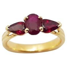 Classic Three Stone Round Ruby Ring, Formal Ruby Three-stone Rings, Luxury Ruby Three Stone Rings, Classic Yellow Gold Three Stone Ruby Ring, Classic Three Stone Ruby Ring In Yellow Gold, Classic Three Stone Yellow Gold Ruby Ring, Classic Three Stone Ruby Promise Ring, Three Stone Ruby Ring In 14k Yellow Gold, Classic Three-stone Ruby Ring