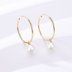 Unveil your elegance with our Freshwater Pearl Drop Large Hoop Earrings. Carefully constructed gold vermemil on Sterling Silver, these hoops offer a harmonious blend of contemporary grace and timeless appeal. The attached freshwater pearl renders a classic touch, creating a versatile piece that suits both everyday elegance and sophisticated soirées. Immerse yourself in the delicate charm and modern luxury of this exquisite pair. Pearls size: 8-9mm 14k Yellow Gold Filled Round Pearl Earrings, Elegant Gold Huggie Earrings With Pearl Charm, Classic Gold Hoop Earrings With Pearl Charm, Yellow Gold-plated Hoop Earrings With Pearl Charm, Elegant Gold Pearl Huggie Earrings, Dainty Yellow Gold Hoop Earrings With Pearl, Classic Gold Pearl Huggie Earrings, Minimalist Yellow Gold Hoop Earrings With Pearl Charm, Delicate Yellow Gold Round Hoop Earrings