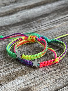 Waterproof Matching Bracelets These lovely bracelets were made using waterproof cord and silver stars. Designed for everyday wear.  The "mommy" bracelet closes to 5.75" The little bracelet has an adjustable closure that will fit a 5" wrist. Trendy Adjustable Star Friendship Bracelets, Adjustable Silver Nylon Cord Friendship Bracelets, Playful Personalized Rainbow Bracelets, Rainbow Star-shaped Bracelet For Gift, Multicolor Star-shaped Bracelet With Colorful Beads, Rainbow Hand-strung Bracelets For Beach, Bohemian Rainbow Stretch Bracelet Hand-strung, Matching Bracelets, Silver Stars