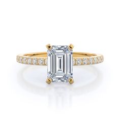 an emerald cut engagement ring with two side stones