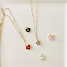 These cute enamel hearts are accented with a cubic zirconia stud to add just the right amount of sparkle. Available in red, light pink, white, or black. Looking for more sparkle? Then the cubic zirconia heart is the one for you. Charms are gold-plated. Chain and clasps are gold-filled. Necklace length available in 18” or 20”. FREE SHIPPING on all orders! Mini Charm Necklace, Mini Charm, Gold Charm Necklace, Red Light, Necklace Length, Are You The One, Charm Necklace, Pink White, Gold Filled