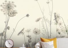 a bedroom with wallpaper and a clock on the table in front of it that is decorated with wildflowers