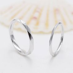 two silver rings sitting on top of each other