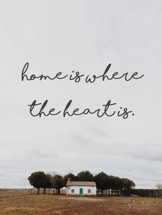 a house with the words home is where the heart is written in black on it