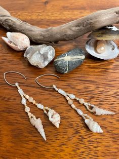 The 'Mermaid's Delight' earrings will transport you to a warm day at the coast with your toes in the sand and the sunlight glinting off the waves. Two different small shells dangle at the bottom of each earring. Mother of pearl, freshwater pearl, heishi shell, and peach and cream colored round shell beads, and white, matte cream, and reflective gold glass seed beads decorate them. They are light weight, unique, and made with beautiful natural treasures. You may not be able to be at the beach everyday, but you can wear a little bit of it through your everyday life! Beaded Shell Earrings, Shell Beaded Jewelry, Beach Earrings With Dangling Beads, Beachy Shell Dangle Earrings, Bohemian Shell Dangle Earrings, Bohemian Dangle Shell Earrings, Handmade Shell Earrings For Summer, Bohemian Shell Jewelry With Pearl Drop, Beach Shell Dangle Earrings