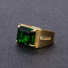 Stop the show with this beautiful cocktail ring. Stainless steel ring with 24K gold plating, set with a large green zircon stone. Adjustable, One Size Fits All Stone Rings For Men, Green Diamond Rings, Mens Ring Designs, Gemstone Diamond Ring, May Birthstone Rings, Men Rings, Mens Gold Jewelry, Green Stone Rings, Engagement Rings Affordable