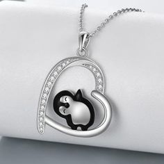 Introducing our charming Penguin Necklace, featuring a heart-shaped penguin design that symbolizes everlasting friendship. This necklace makes a fantastic gift for women who have a deep affection for penguins, whether they are sisters, brothers, or dear friends. Crafted from Hypoallergenic real 925 sterling silver, this Penguin Necklace prioritizes your health and comfort. It's Nickel-free, Lead-free, and Cadmium-free, ensuring that long-term wear keeps you in good health. The penguin pendant measures 21.8 mm by 29.8 mm (0.86 inches by 1.17 inches) and hangs gracefully from a 1.2 mm O chain that's 18 inches long. This necklace is a delightful accessory that beautifully captures the essence of friendship and love. Wear it proudly to symbolize your cherished relationships and your affection Penguin Pendant, Penguin Jewelry, Penguin Necklace, Penguin Design, Silver Sisters, Sunflower Jewelry, Sterling Silver Cross Necklace, Sterling Silver Heart Pendant, Sterling Silver Cross Pendant