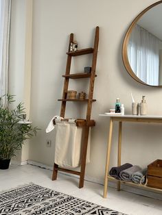 a bathroom with a wooden ladder leaning up against the wall next to a bathtub