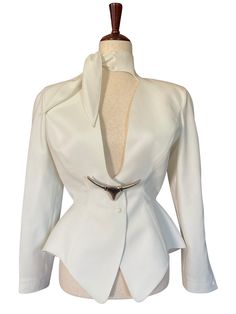 Thierry Mugler Jacket Documented Runway Collection S/S 1992. RARE Dramatic Jacket Size 38 (France). Absolutely extraordinary piece! Sculptural dramatic ivory jacket with built in necktie and silver bull brooch. This truly is wearable Art. Extremely rare collectors piece. Muséum Held at FIDM  Marked Vintage Size 38 Made in France Thierry Mugler Vintage, Mugler Jacket, Mugler Blazer, Vintage Mugler, France Video, Jacket Runway, Vintage Thierry Mugler, Office Siren, Press Tour