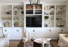 a living room filled with furniture and a flat screen tv