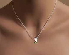 "Peridot Necklace - Argentium Silver - 3460 - Argentium Chain Included Make a statement with this modern artisan crafted pendant. ( IMPORTANT - PLEASE READ 1. AND 2 BELOW ) 1.) INCLUDED IN THE PRICE IS AN ARGENTIUM SILVER CHAIN APPROPRIATE FOR THE PENDANT CHOSEN. YOU CAN CHOOSE FROM 16\", 18\" OR 20\" LENGTH AT CHECKOUT. 2.) PLEASE LOOK AT THE MEASUREMENTS CAREFULLY. SOME PHOTOS HAVE BEEN ENLARGED TO SHOW DETAIL, WHILE OTHERS HAVE BEEN MINIMIZED TO FIT THE FRAME. ACTUAL SIZE CANNOT BE DETERMINED Modern Peridot Jewelry For Gift, Modern Peridot Jewelry As A Gift, Modern Silver Peridot Jewelry, Modern Silver Jewelry With Peridot, Modern Green Birthstone Jewelry, J Necklace, Green Topaz, Modern Necklace, Peridot Pendant