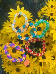 there are many bracelets on top of the sunflowers in the field together