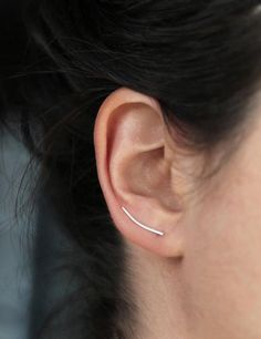 { P r o d u c t }A delicate and elegant ear climber that draws a simple line on your ear and is secured on the back. Available individually or in pair.{ M a t e r i a l s }- sterling silver{ D i m e n s i o n s }- about 30mm long (just over an inch)Please note that the model is wearing her own ear climber, a new one will be made especially for you!{S h i p p i n g }- Canada: We offer free shipping on all orders over CAD $40.- USA: All orders are shipped with a tracking number. USD $35+ orders sh Ear Lobe Piercings, Ear Crawler, Cute Ear Piercings, Ear Crawlers, Scrapbook Tag, Ear Climber, Ear Climbers, Handmade Tags, Silver Earring