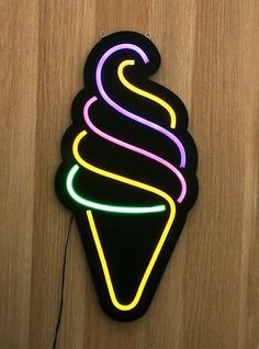 an ice cream sundae neon sign on a wooden surface with a cord attached to it