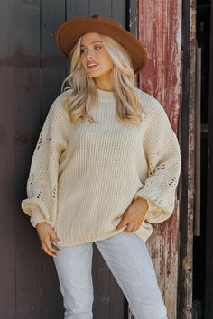 This Crochet Sleeve Pullover Sweater in Cream offers a chic blend of texture and style! Featuring long balloon sleeves with intricate crochet detailing, this sweater adds a unique flair to any outfit. It has a round neckline with ribbed detailing at the neckline, cuffs, and hem, enhancing its cozy feel. Designed with an oversized fit, it's perfect for layering and everyday comfort. Style with jeans, ankle booties, and a wide brim hat for an elevated chic outfit. Chic Long Sleeve Pointelle Knit Top, Chic Balloon Sleeve Sweater For Spring, Trendy Balloon Sleeve Sweater For Fall, Trendy Balloon Sleeve Fall Sweater, Winter Knit Sweater With Lantern Sleeves, Spring Sweater With Balloon Sleeves, Cream Long Sleeve Pointelle Knit Sweater, Winter Pointelle Knit Sweater With Puff Sleeves, Fall Cable Knit Sweater With Puff Sleeves