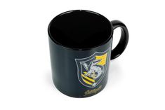 a black coffee mug with a yellow and white crest on the side, sitting in front of a white background