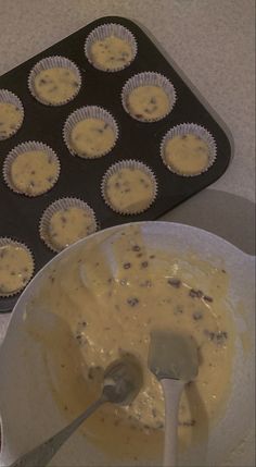 cupcake batter being poured into a muffin tin