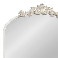 The Arendahl wall mirror brings a brilliant and decadent accent to any traditional home design. This wall mirror features a baroque-inspired design, with a resin garland crown cascading down an arched iron frame. The antique white finish brings it together as a vintage piece to display anywhere in your coastal home seeking additional light and elegance. Due to its hand-finished craftsmanship, each piece may vary in appearance. Showcase it in your living room, bedroom, entryway, bathroom vanity, Mirrors Over Nightstands, Cottage Bathroom Mirrors, Mirrors For Bathroom Vanity, Vintage Bathroom Mirrors, Vintage Vanity Mirror, Traditional Home Design, White Mirror Frame, Arch Wall Mirror, French Fireplace