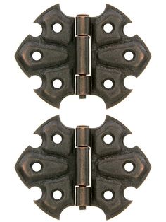 pair of black iron door hinges on white background