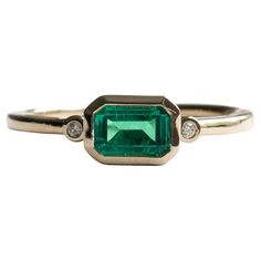 East west emerald stone bezel with diamonds set on 14k yellow gold. Stone Shape: Emerald Stone Type: Lab-created emerald Metal Type: 14 Karat Yellow Gold Stone size: 4mm x 6mm Band width: 1.7mm Diamond Clarity: VS Diamond Color: G-H Size 7 is ready to ship Art Deco Baguette Ring, Masculine Engagement Rings, Green Stone Ring, Emerald Ring Engagement Diamond, Bezel Set Engagement Ring, Emerald Rings, Engagement Ring Art Deco, Green Stone Rings, Lab Created Emerald