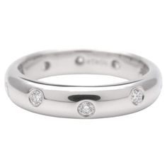 a white gold wedding ring with three diamonds