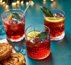 three glasses filled with different types of drinks and pastries on top of a table