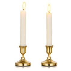 two white candles sitting next to each other