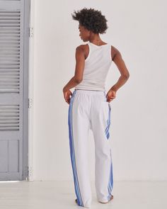 Our Classic Trousers have a relaxed, baggy fit that combines comfort and style, featuring our signature contrast stripe along the side of the leg. Equipped with three practical pockets, an elasticated waistband and a convenient drawstring, they are trousers you'll want to live in. Originally inspired by Kenyan Kikoy fabric. Three Stripes Relaxed Fit Sportswear Pants, Relaxed Fit Three Stripes Sportswear Pants, Relaxed Fit Sportswear Bottoms With Three Stripes, Relaxed Fit Sportswear Pants With Three Stripes, Sporty Relaxed Fit Sweatpants With Three Stripes, Relaxed Fit Three Stripes Sweatpants For Jogging, Summer Sportswear Bottoms With Three Stripes, Relaxed Fit Athleisure Joggers With Three Stripes, Spring Joggers With Side Stripes For Jogging