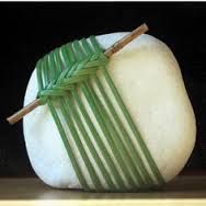 a close up of a piece of food with bamboo sticks sticking out of the top