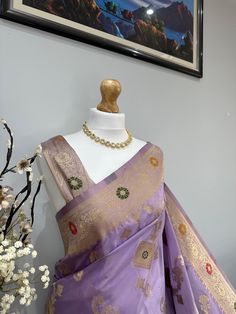 Discover the timeless beauty of our high-quality Banarasi silk saree, perfect for any occasion. The golden zari not only enhances the intricate designs but also gives the saree a shiny, opulent look. It drapes elegantly, ensuring you make a stunning statement at weddings, festivals, and formal events.This saree comes with an unstitched blouse. Elegant Paithani Silk Blouse Piece With Meenakari, Festive Gold Katan Silk Blouse Piece, Elegant Meenakari Blouse Piece For Festive Occasions, Traditional Drape Katan Silk Saree With Zari Weaving, Traditional Katan Silk Saree With Zari Weaving, Katan Silk Saree With Zari Weaving In Traditional Drape, Purple Dola Silk Traditional Wear With Meenakari, Elegant Dola Silk Traditional Wear With Zari Weaving, Elegant Tussar Silk Blouse Piece With Meenakari