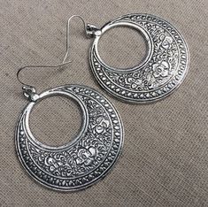 "These are fabulous and chic boho floral hoop earrings!  Make a statement without saying a word with these versatile earrings.  Perfect for everyday wear, dress them up or down! The hoops measure 1 5/8\" long by 1 1/2\" wide.  They hang from simple silver ear wire hooks.  Overall drop length is just under 1 3/4\".  Made from plated silver. I have this same earring style also available in gold. Here is a direct link to those... https://www.etsy.com/listing/1524279410/ Thanks so much for stopping Silver Boho Earrings, Big Silver Earrings, Big Dangle Earrings, Bohemian Flower, Boho Hoop Earrings, Statement Hoop Earrings, Earrings Big, Statement Drop Earrings, Disc Earrings