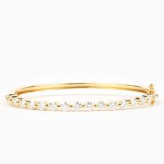 Rise to the occasion with the Lucia Bangle Bracelet! This sparkling bangle is crafted with individual set round moissanites to offer a luxurious, elevated sparkle. Made in a 4mm width, it is perfect to wear solo or stack with other bracelets, making it the ideal accessory for day or night. Stackable Diamond Bracelet For Anniversary, Timeless Stackable Diamond Bracelets, Timeless Stackable Diamond Tennis Bracelet, Timeless Diamond Stackable Tennis Bracelet, Timeless Diamond Tennis Bracelet Stackable, Formal Stackable Diamond Bracelet, Timeless Stackable Cubic Zirconia Diamond Bracelet, Stackable Cubic Zirconia Diamond Bracelet In White Gold, Stackable White Gold Cubic Zirconia Diamond Bracelet